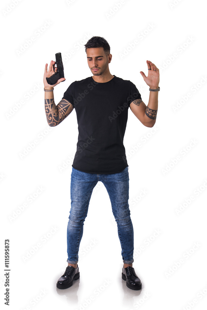 Handsome man with gun holding raised arms Handsome man with gun holding raised arms