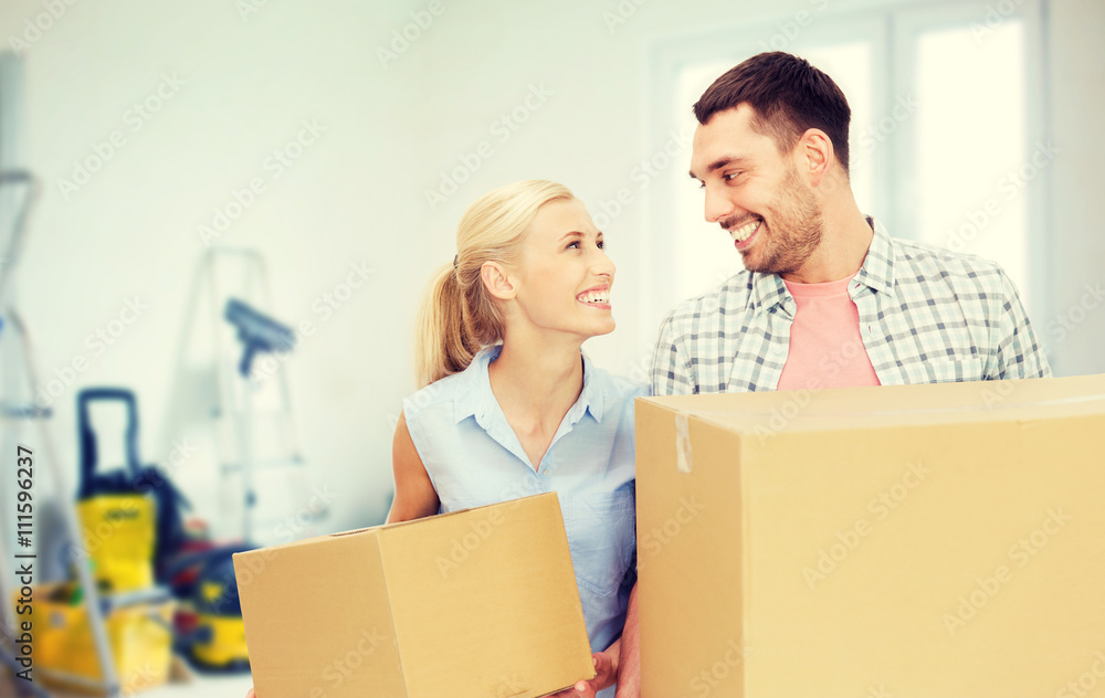 couple with cardboard boxes moving to new home couple with cardboard boxes moving to new home