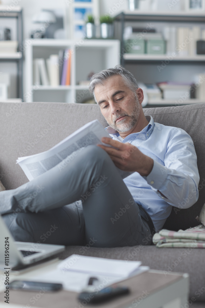 Businessman reading a newspaper Businessman reading a newspaper