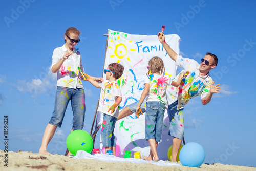 Happy family playing on the beach at the day time. photo