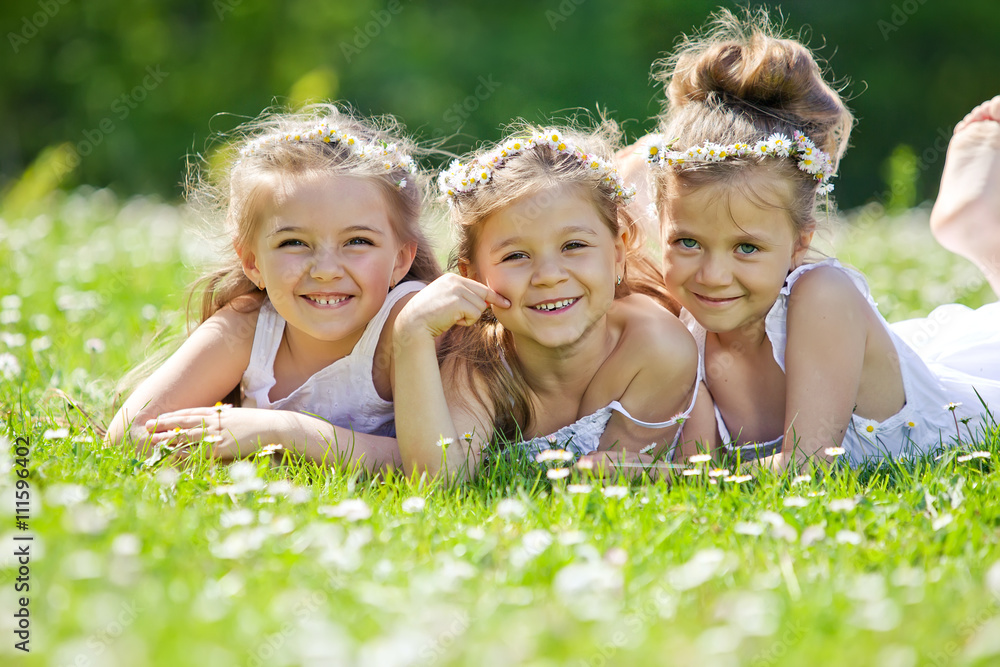 Happy girls are playing on the camomile field Happy girls are playing on the camomile field