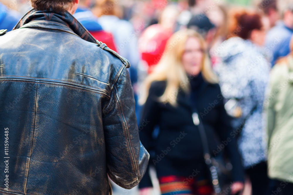 man with leather jacket in a crowd of people man with leather jacket in a crowd of people