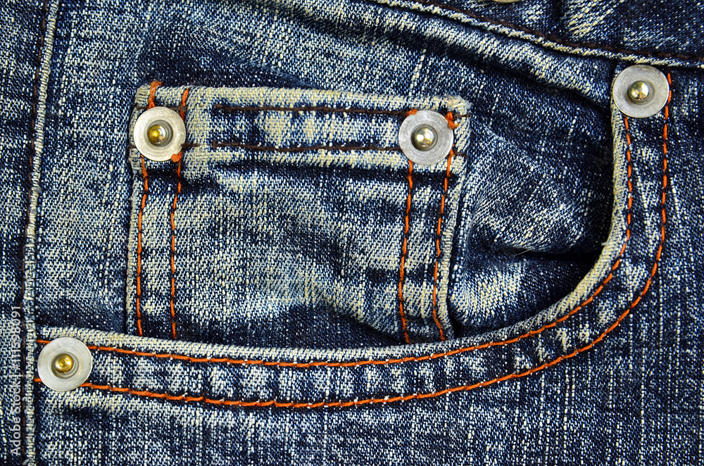 Blue jeans fabric texture with pocket and buttons.Jeans background. Denim background.