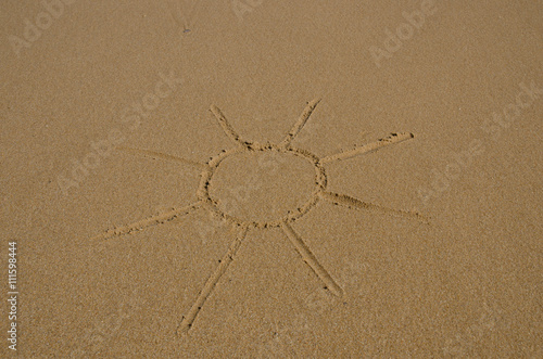 Picture of the sun drawn in wet sand