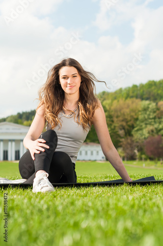 Healthy beautiful woman practicing pilates in the nature