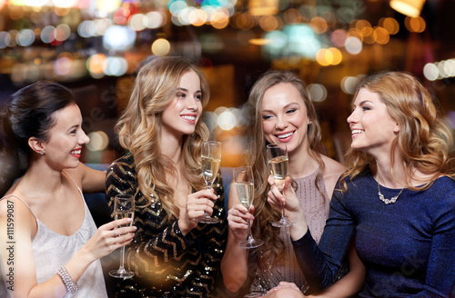 happy women with champagne glasses at night club