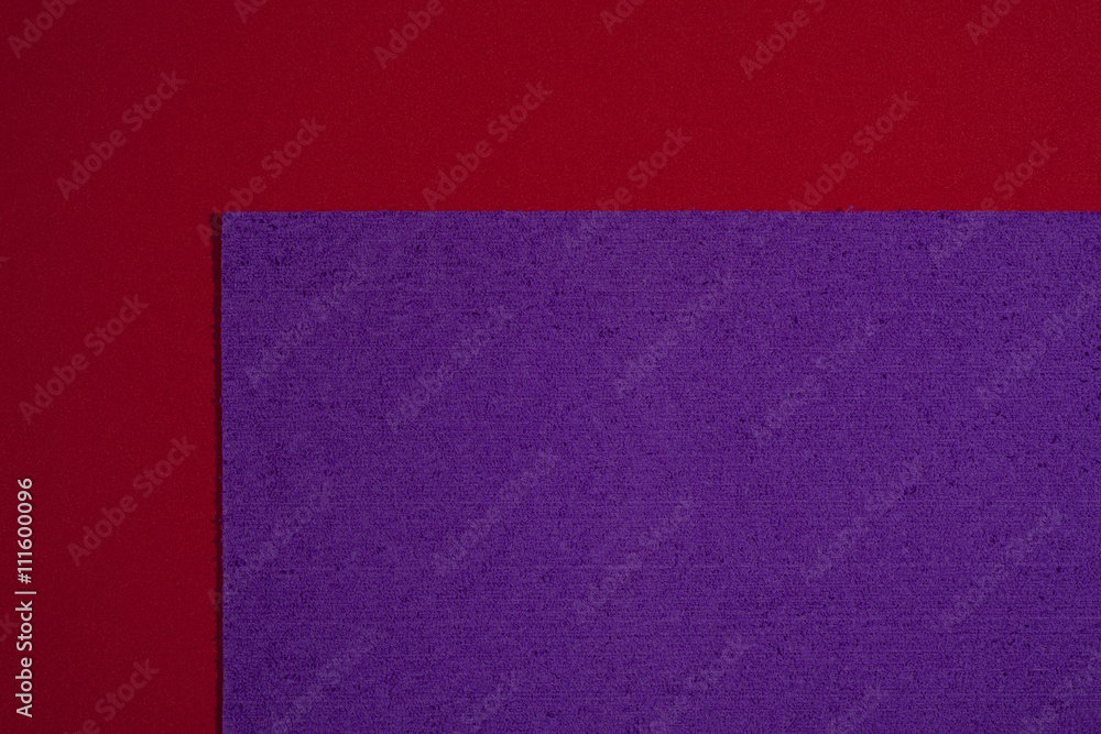 Fototapeta premium Eva foam ethylene vinyl acetate sponge plush purple surface on red smooth background