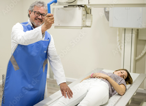 Adult doctor with patient on x-ray machine