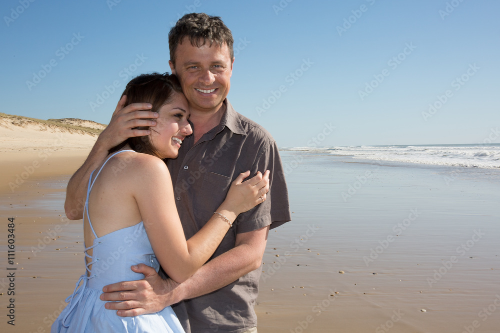 Attractive couple on the beach on a sunny day Attractive couple on the beach on a sunny day