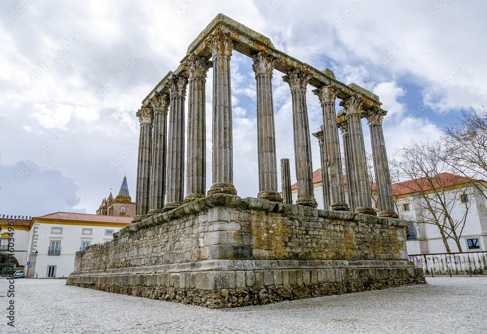 Evora, Portugal. The iconic Roman Temple dedicated to the Emperor cult, wrongly considered as a Goddess Diana Temple, with the Loios Convent used as a Historical Hotel. UNESCO World Heritage Site.