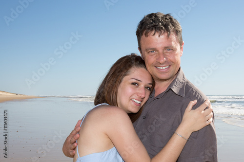 Beautiful couple embracing on the beach on vacation