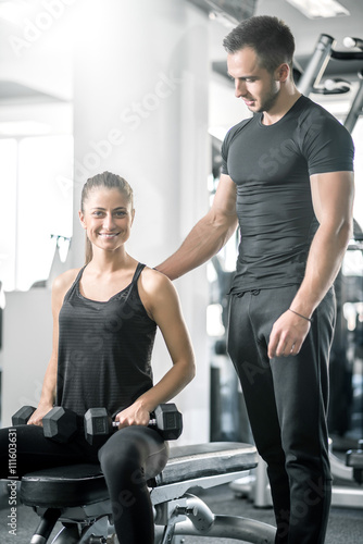 Personal trainer talks to his client.