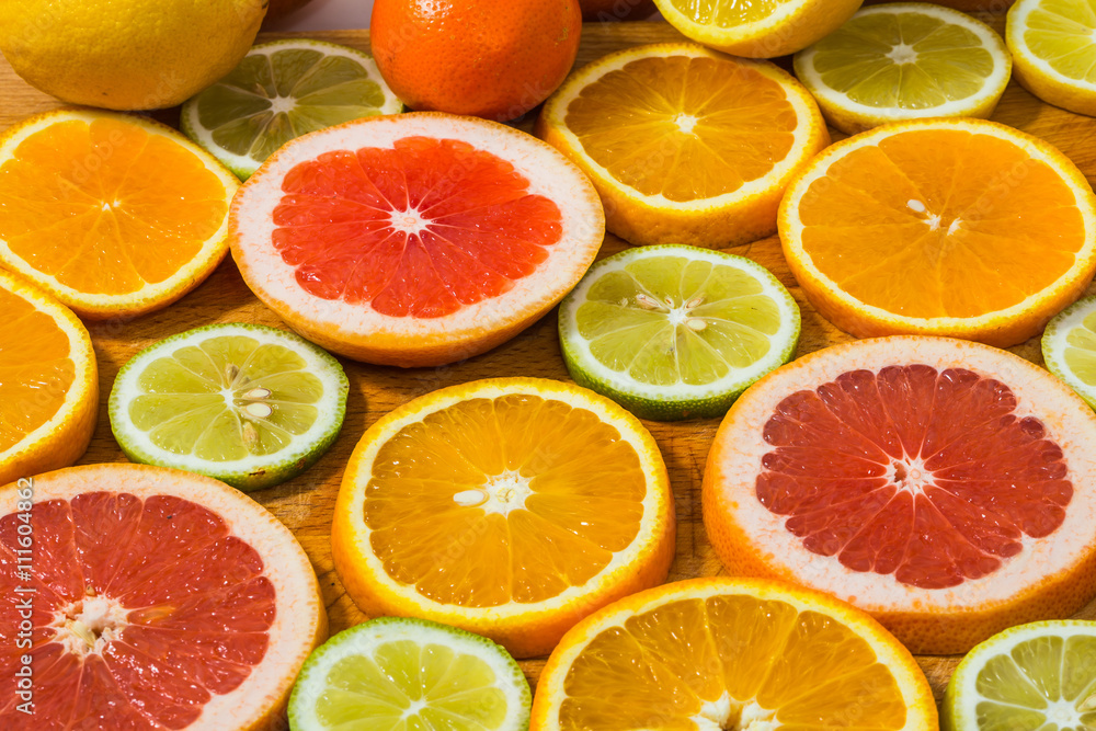 Citrus fruit background with sliced f oranges lemons lime tanger Citrus fruit background with sliced f oranges lemons lime tanger