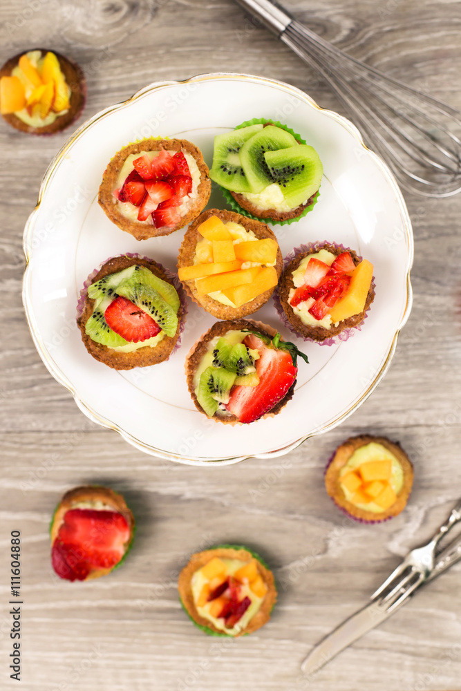 top view of mini pastry with custard cream and fresh fruits top view of mini pastry with custard cream and fresh fruits