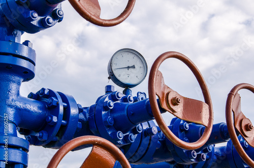 Wellhead with valves and manometer. Oil and gas concept.