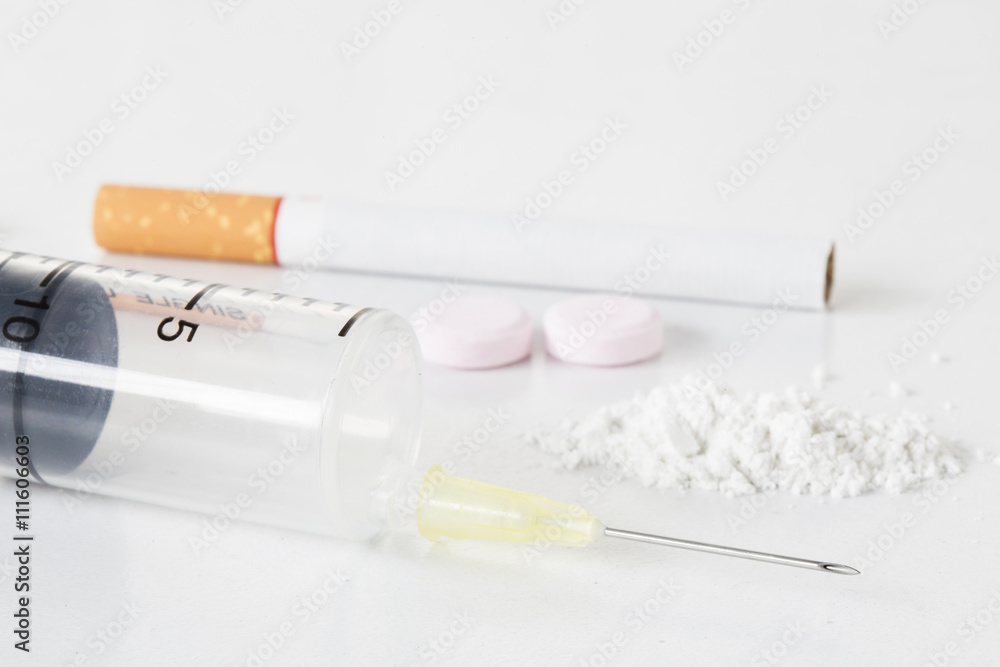 Drugs cigarette narcotic pill on white background. Drugs cigarette narcotic pill on white background.