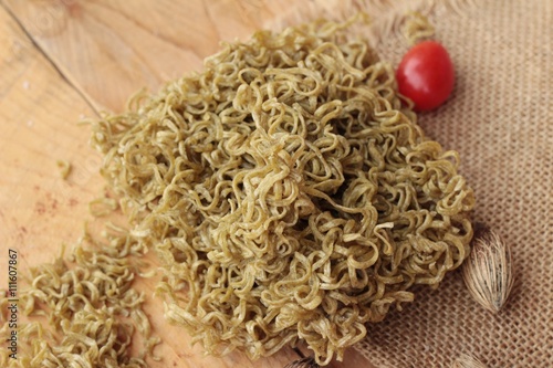 Dry instant vegetable noodle on wood background.