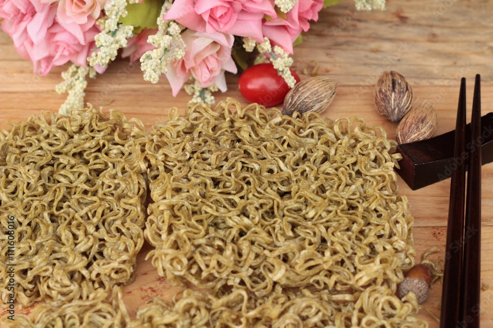 Dry instant vegetable noodle on wood background.
