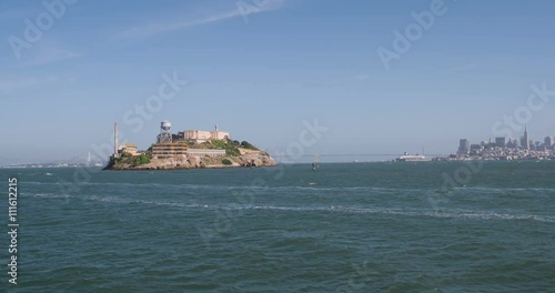 Boat view from water of Alcatraz and city of San Francisco in background.
