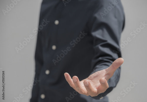 Business Asian male in black shirt holding something with hand with copy space . You can add anything in the copyspace