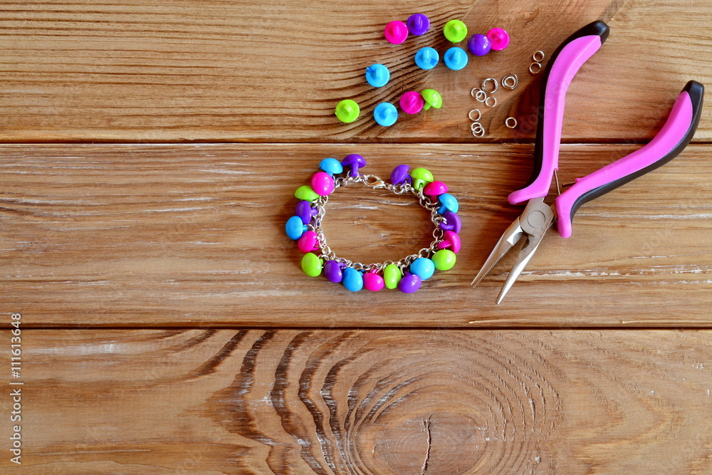 Handmade button bracelet. Set of bright colored buttons, pliers
