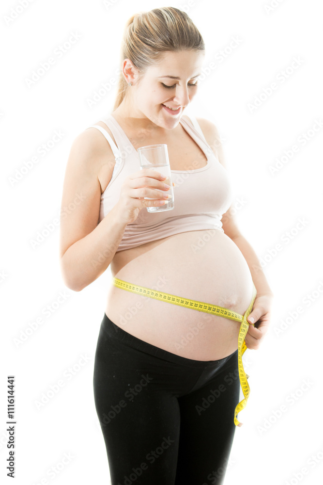 happy pregnant woman measuring belly with measuring tape happy pregnant woman measuring belly with measuring tape