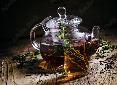 Azerbaijan black tea with fresh thyme in the eastern glass and g