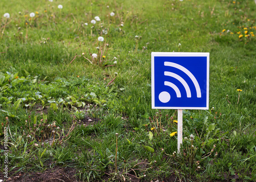 WiFi sign on a green lawn. Free wifi simbol. 