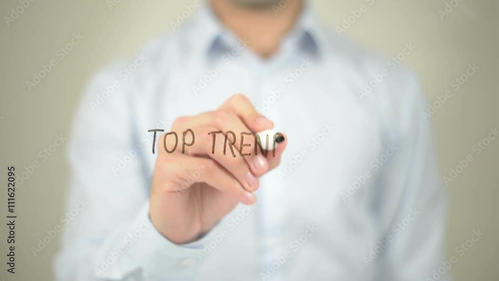 Top Trending, man writing on transparent screen Top Trending, man writing on transparent screen