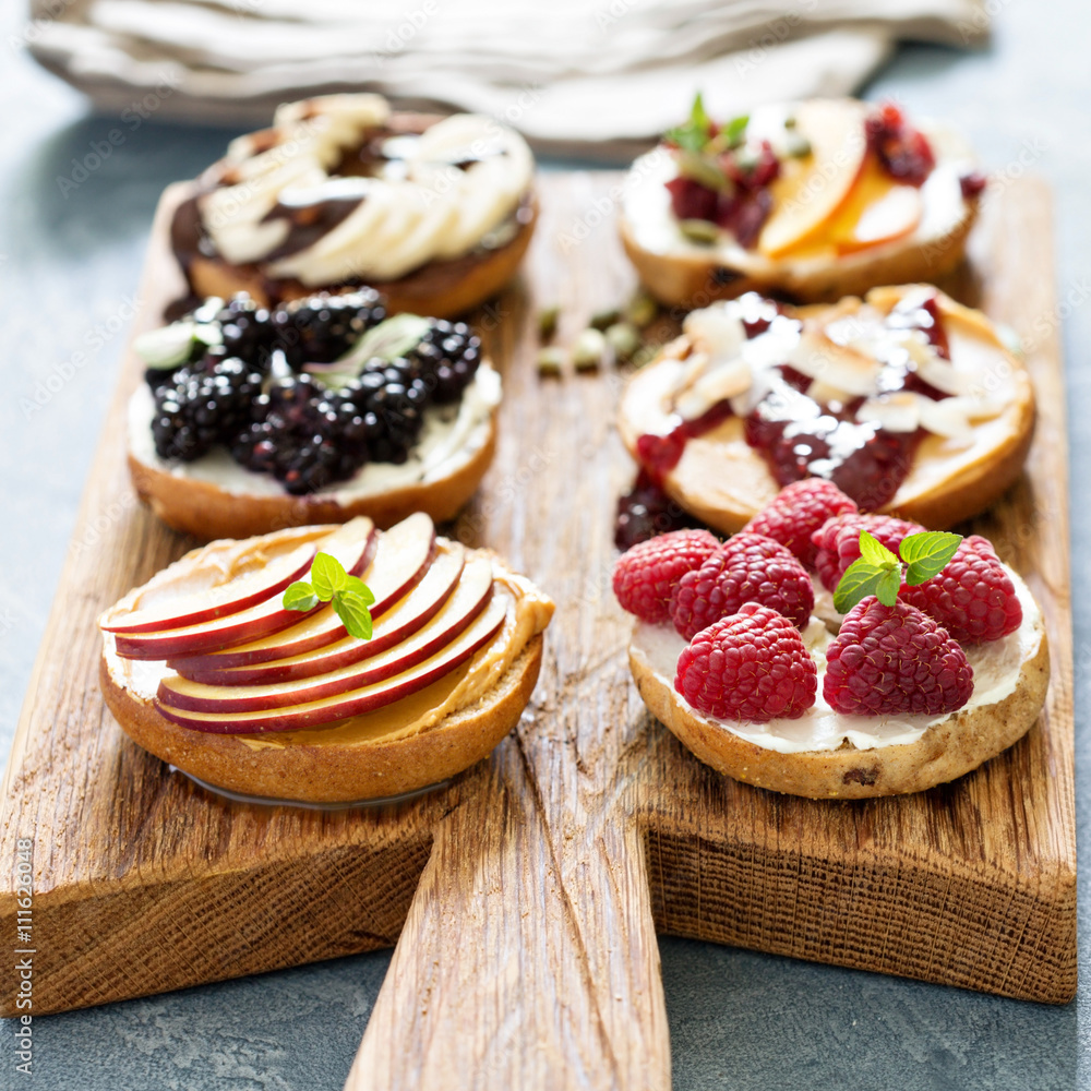 Variety of bagels on a board Variety of bagels on a board