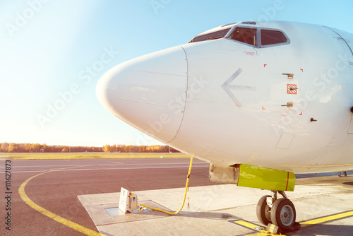 Front profile and cockpit windows of wide-body airplane.