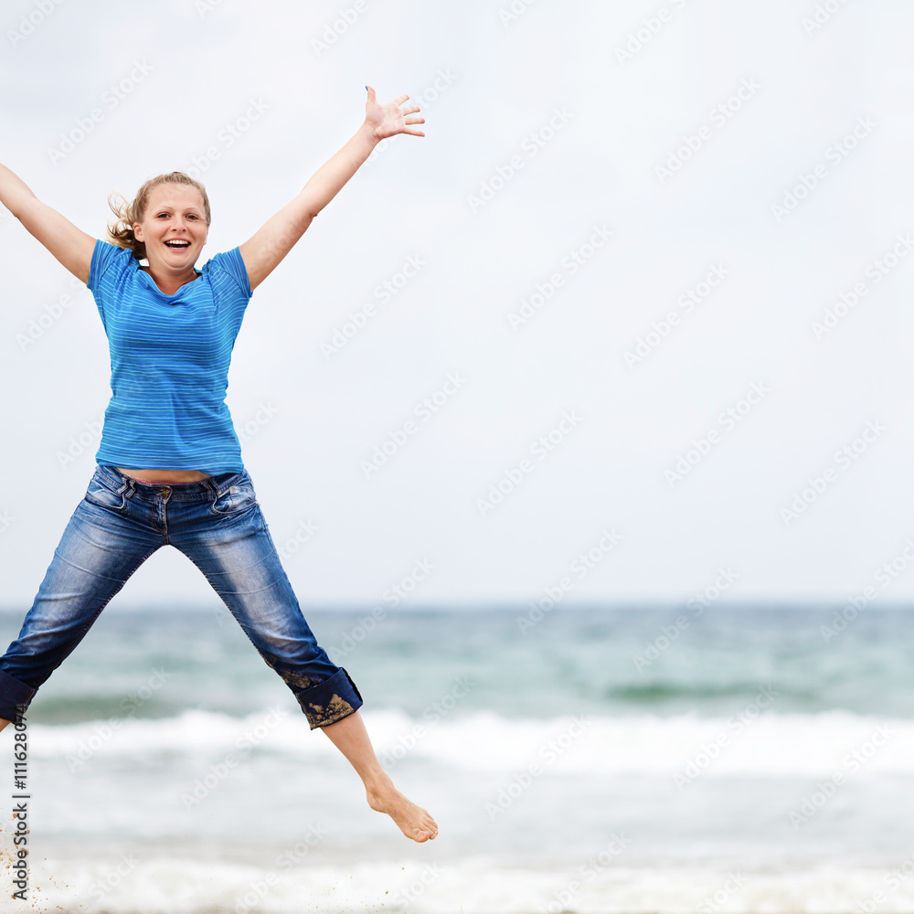 Happy young blonde woman jumping outdoors. Jumping girl. Selective focus on the model. Space for text. Happy young blonde woman jumping outdoors. Jumping girl. Selective focus on the model. Space for text.