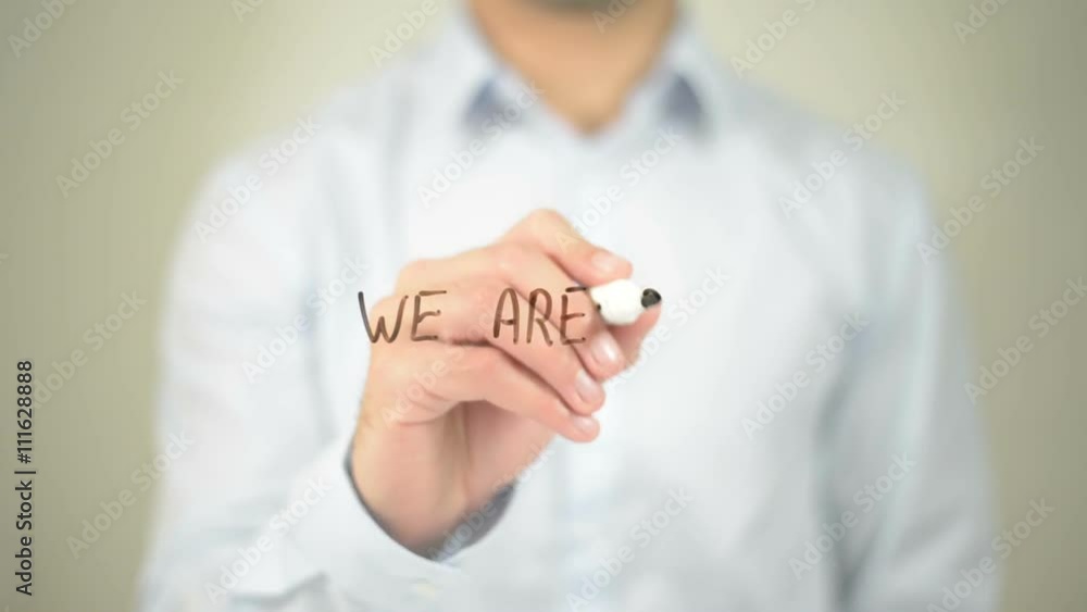 We Are Open, man writing on transparent screen We Are Open, man writing on transparent screen