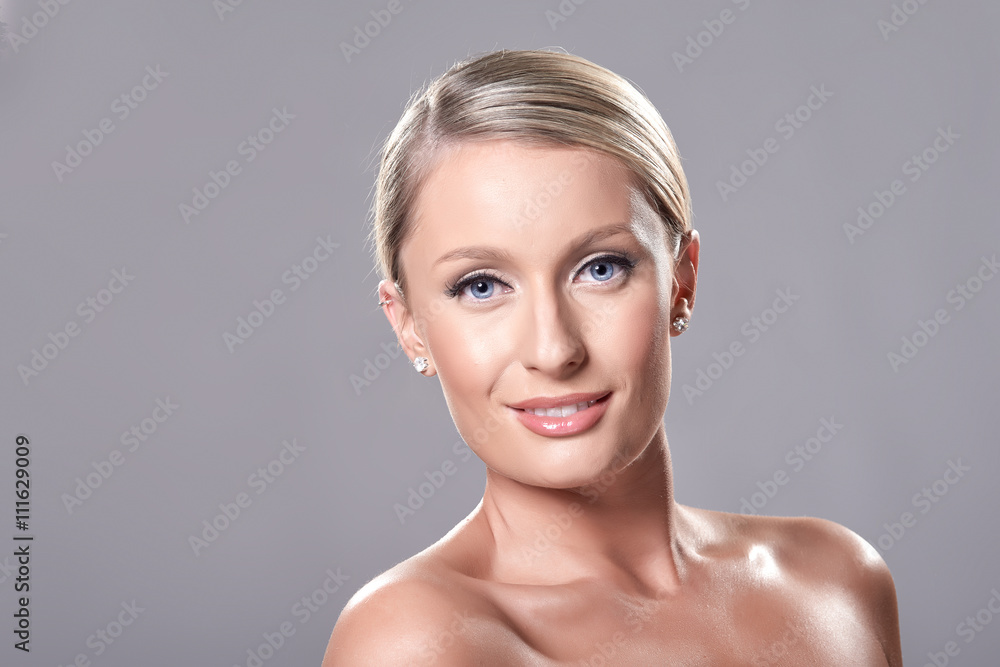 Portrait of beautiful blond model with blue eyes, on grey backgr Portrait of beautiful blond model with blue eyes, on grey backgr