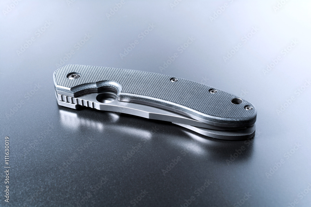 Handle Of A Lying Military Knife Lying On Dark Ground With Reflection Handle Of A Lying Military Knife Lying On Dark Ground With Reflection