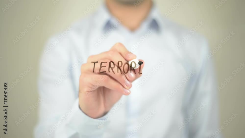 Close up of a man writing Terrorism with black marker pen on transparent screen Close up of a man writing Terrorism with black marker pen on transparent screen