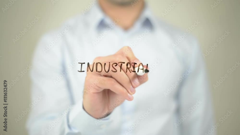 Industrial Growth, man writing on transparent screen Industrial Growth, man writing on transparent screen