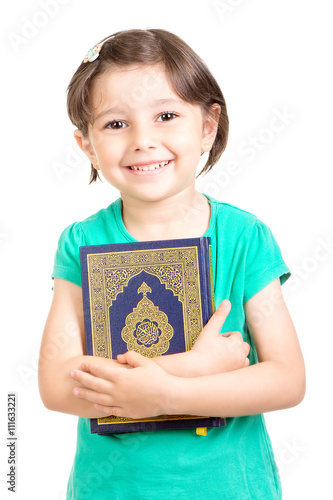 Happy young Muslim girl holding Quraan (Holy book) - Ready for Ramadan