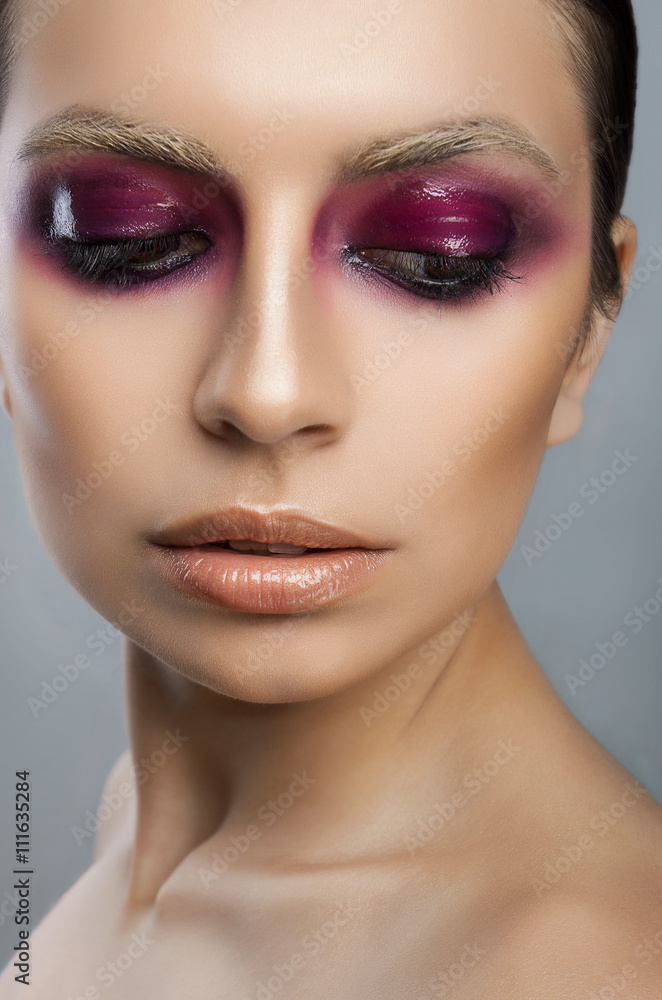 Beautiful face with pink lips and eyes on a white background