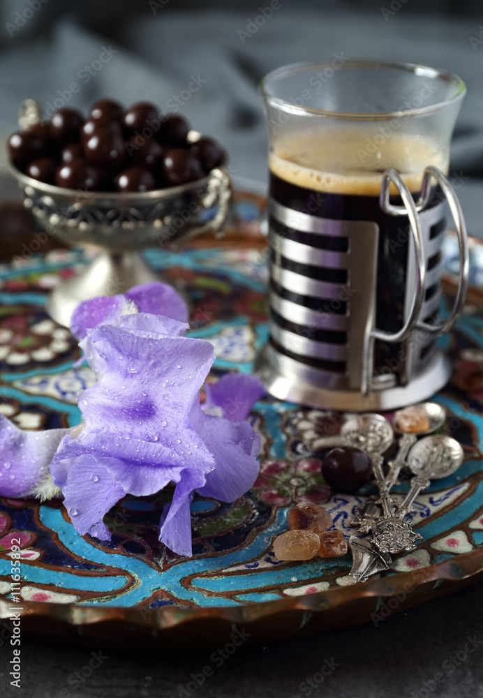 Mug of coffee, chocolate drops and iris flower