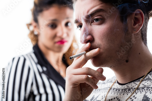 man smoking and woman disappointment