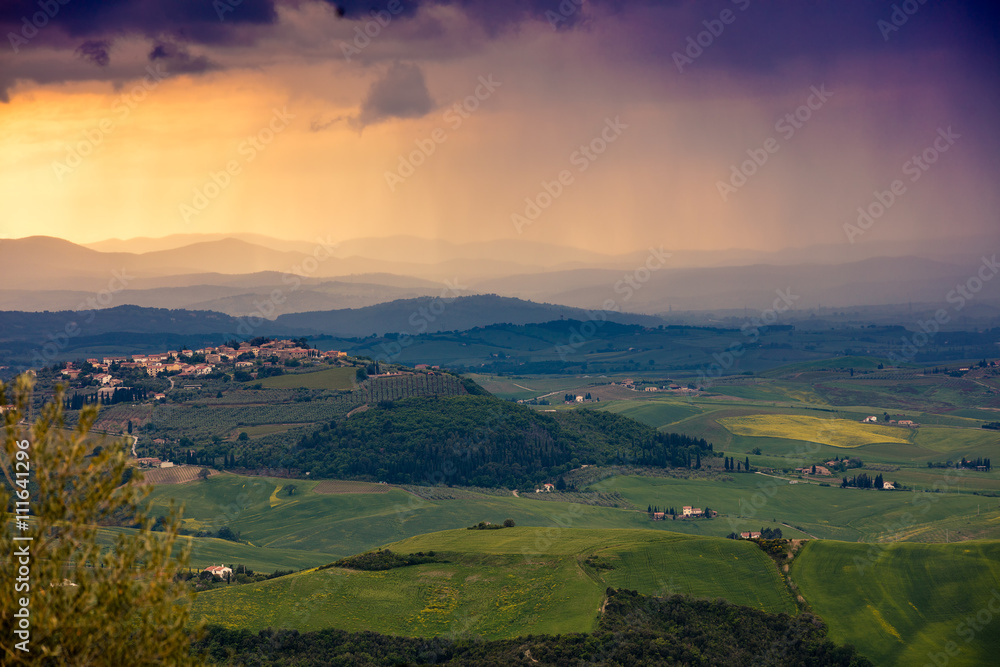 Fototapeta premium Tuscany valley in stormy weather at sunset, Italy