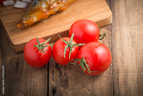 ripe small tomatoes on wood background