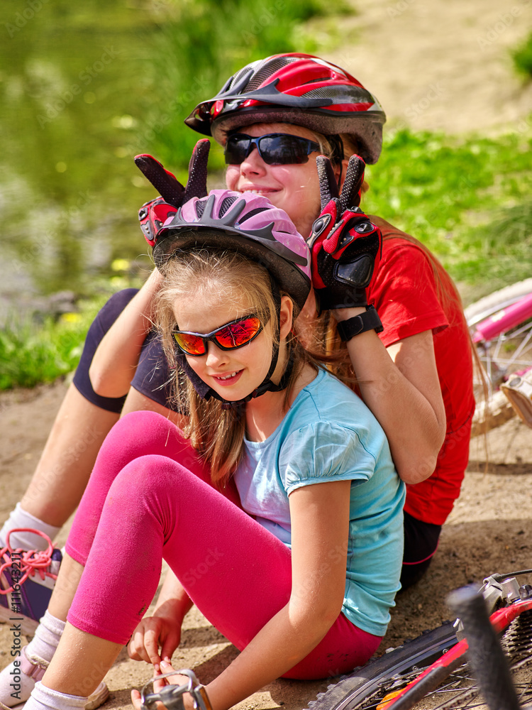 Bikes bicycling family. Happy mother and daughter rides bicycle. Family