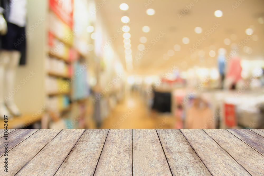 Empty table and blur clothing store with bokeh background Empty table and blur clothing store with bokeh background