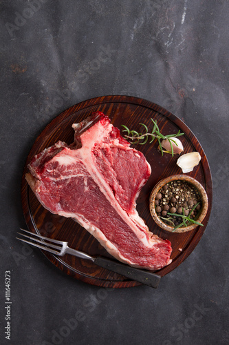Fotografija Thick raw T-bone steak with seasoning