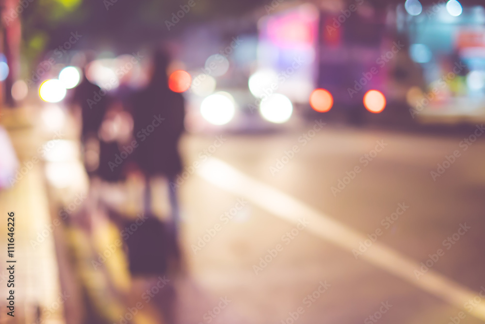 Blurred background : people walking at night on road,abstract ba Blurred background : people walking at night on road,abstract ba