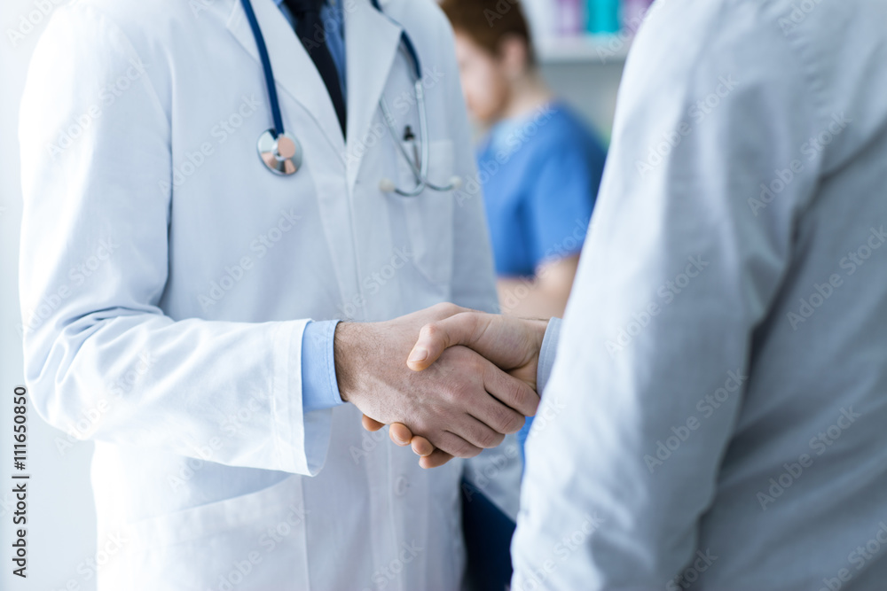 Doctor and patient shaking hands Doctor and patient shaking hands