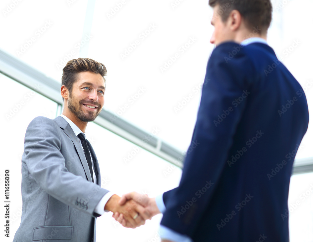 Business colleagues sitting at a table during a meeting with two Business colleagues sitting at a table during a meeting with two
