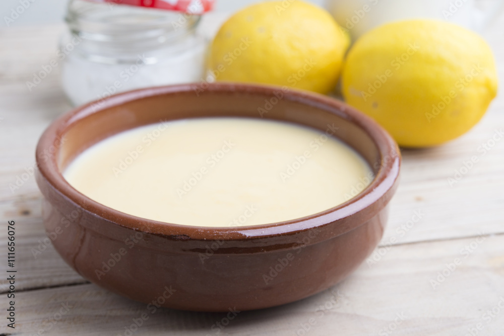 Traditional creme brulee on ceramic dish on wooden table Traditional creme brulee on ceramic dish on wooden table